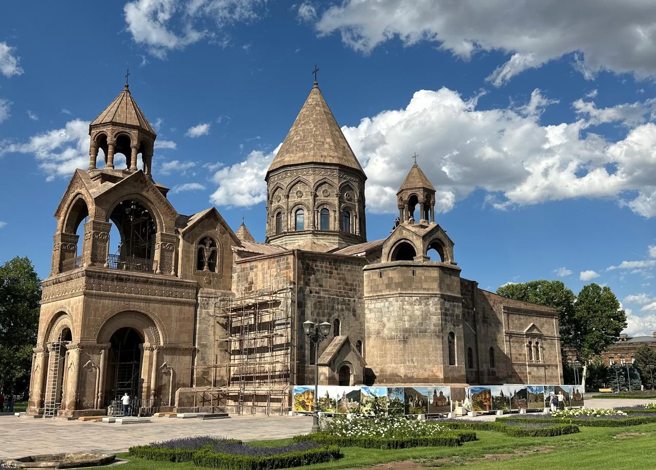 The stone exterior and central dome of the Mother Cathedral of Holy Etchmiadzin in Armenia.